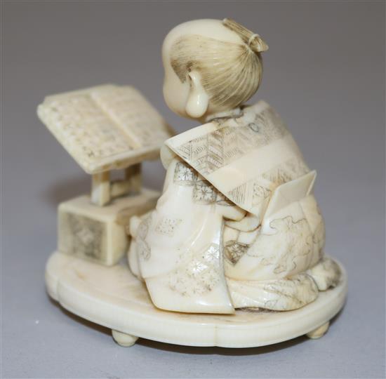 A Japanese Meiji ivory okimono of a scribe, 2.5in.